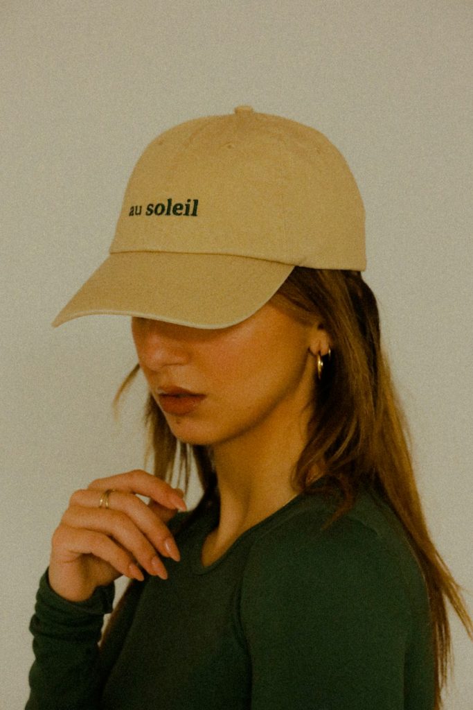 a-woman-wearing-a-hat-with-the-word-solei-on-it-dfkxgbi0lbq