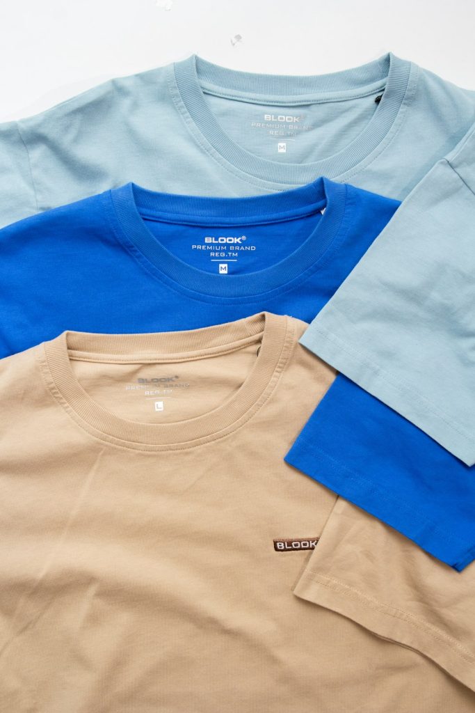 three-different-colors-of-t-shirts-sitting-next-to-each-other-qlgfz3flio4